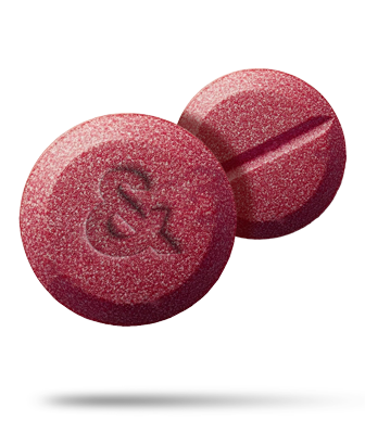 Brown glass bottle with a white dropper against a black background.